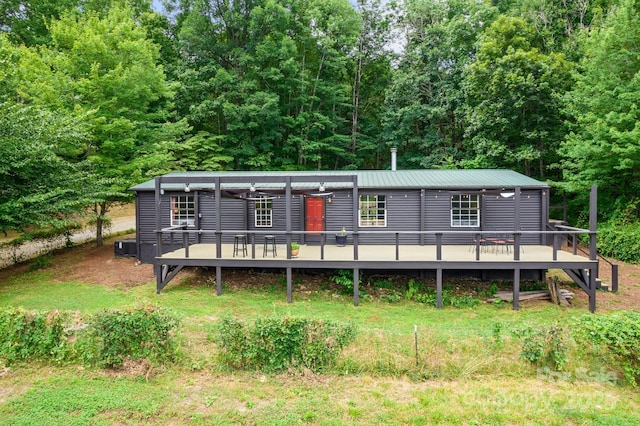 view of front of home with a deck and metal roof