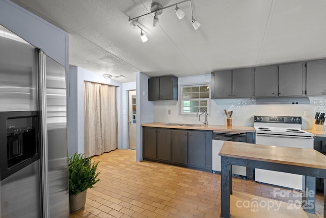 kitchen featuring dishwashing machine, stainless steel refrigerator with ice dispenser, white range with electric cooktop, under cabinet range hood, and light countertops