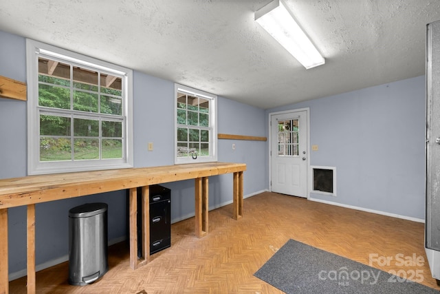 below grade area featuring a textured ceiling and baseboards