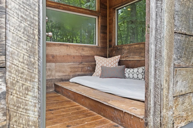 exterior space with wood walls and hardwood / wood-style flooring