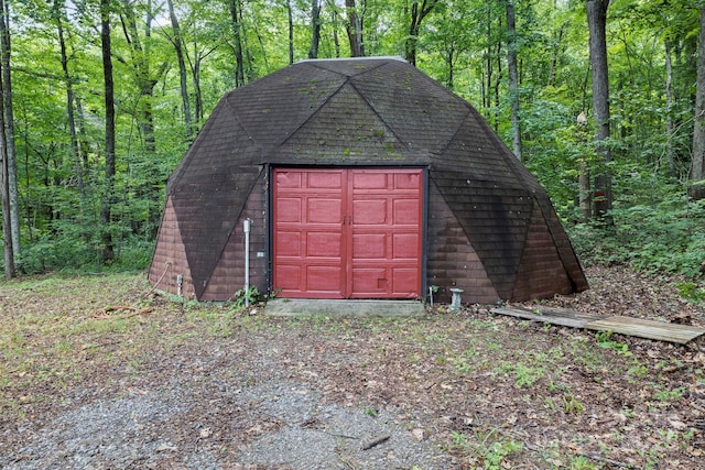 view of outdoor structure featuring an outdoor structure and a forest view