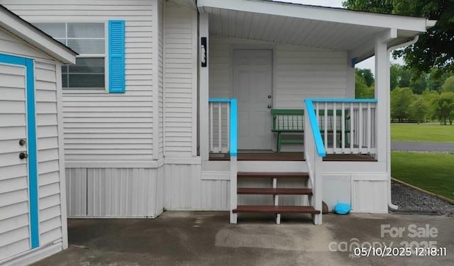 view of exterior entry with a porch