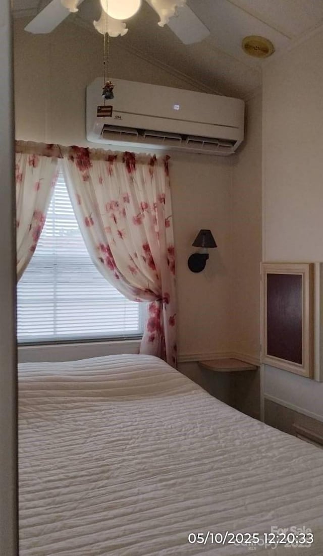 bedroom featuring a wall mounted AC and a ceiling fan