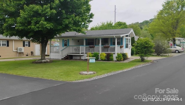 view of front of home featuring covered porch and a front lawn