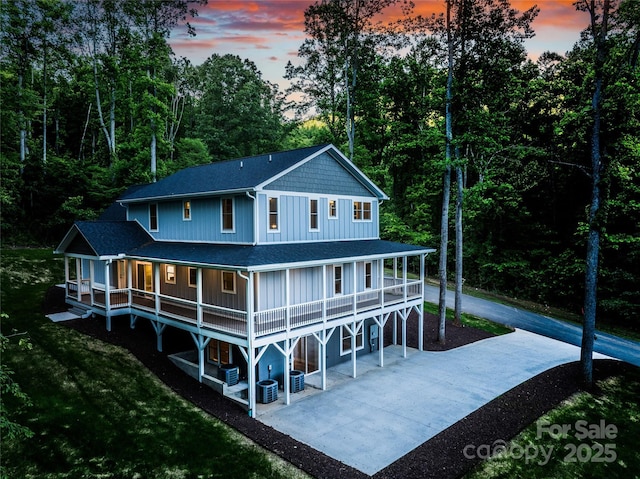 68 Bamboo Trl, Candler, NC 28715 - rear view of property with concrete driveway, a shingled roof, a patio, and central AC
