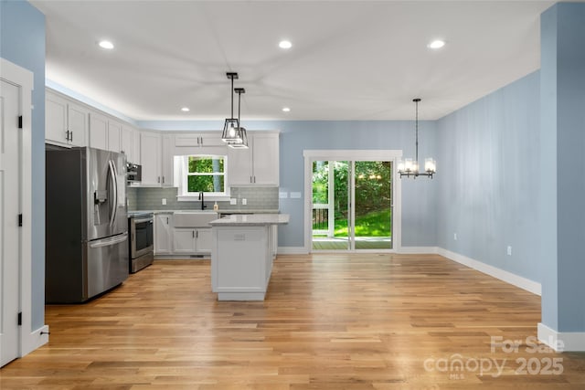 68 Bamboo Trl, Candler, NC 28715 - kitchen featuring stainless steel appliances, light wood-type flooring, decorative backsplash, recessed lighting, and white cabinets