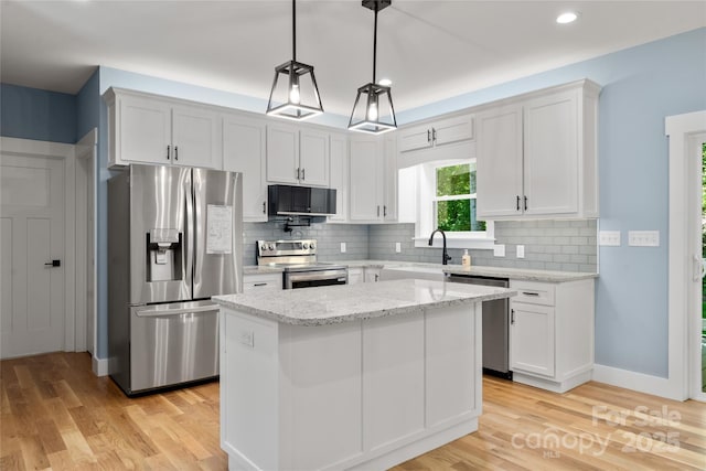 68 Bamboo Trl, Candler, NC 28715 - kitchen with appliances with stainless steel finishes, a sink, light wood finished floors, decorative backsplash, and recessed lighting