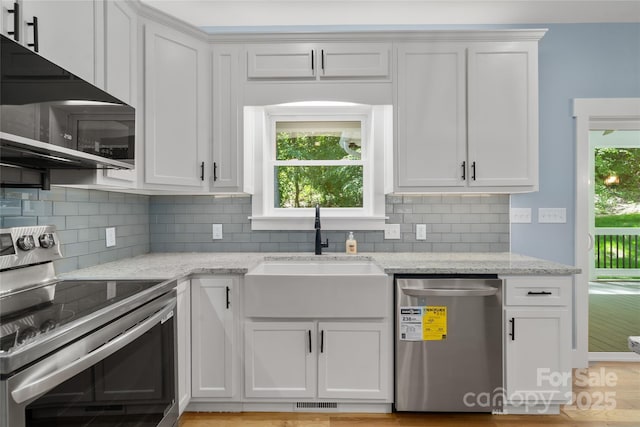 68 Bamboo Trl, Candler, NC 28715 - kitchen featuring appliances with stainless steel finishes, a sink, white cabinets, backsplash, and light stone counters