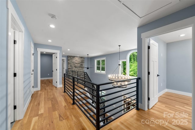 68 Bamboo Trl, Candler, NC 28715 - hall with an upstairs landing, light wood-type flooring, baseboards, a chandelier, and recessed lighting