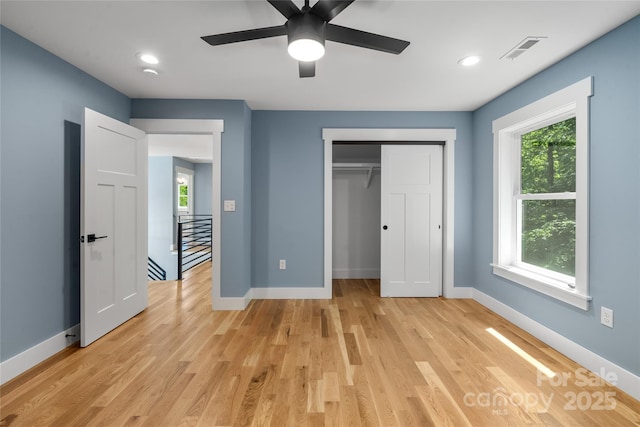 68 Bamboo Trl, Candler, NC 28715 - unfurnished bedroom featuring light wood finished floors, multiple windows, baseboards, and recessed lighting