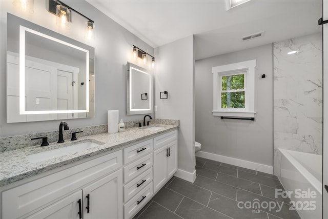 68 Bamboo Trl, Candler, NC 28715 - full bathroom with double vanity, toilet, baseboards, and bathtub / shower combination