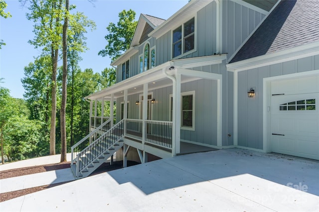 68 Bamboo Trl, Candler, NC 28715 - view of side of property featuring board and batten siding, roof with shingles, a porch, and a garage
