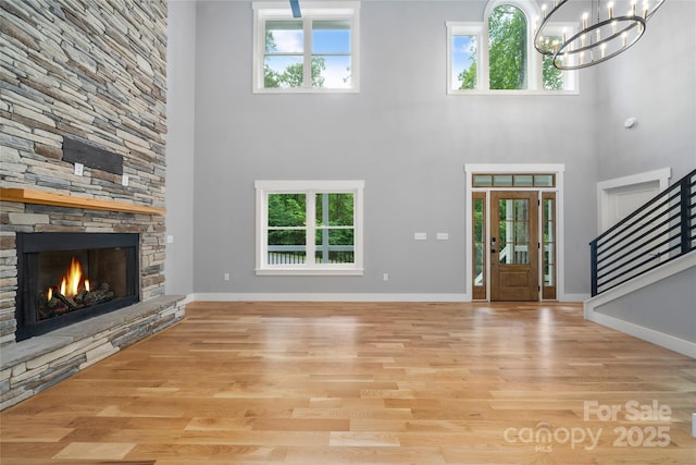68 Bamboo Trl, Candler, NC 28715 - entryway with a towering ceiling, plenty of natural light, wood finished floors, stairs, and a stone fireplace