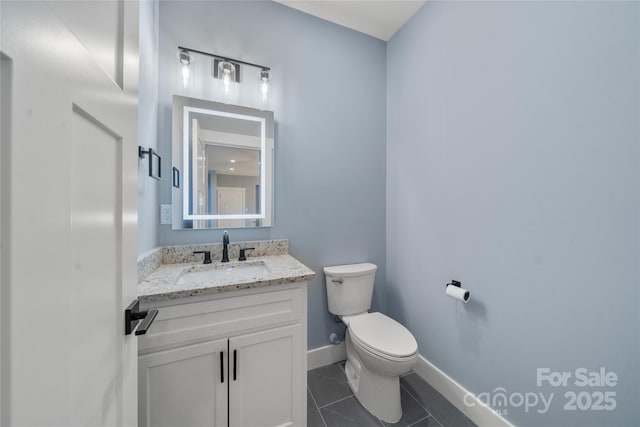 68 Bamboo Trl, Candler, NC 28715 - bathroom with toilet, vanity, baseboards, and tile patterned flooring