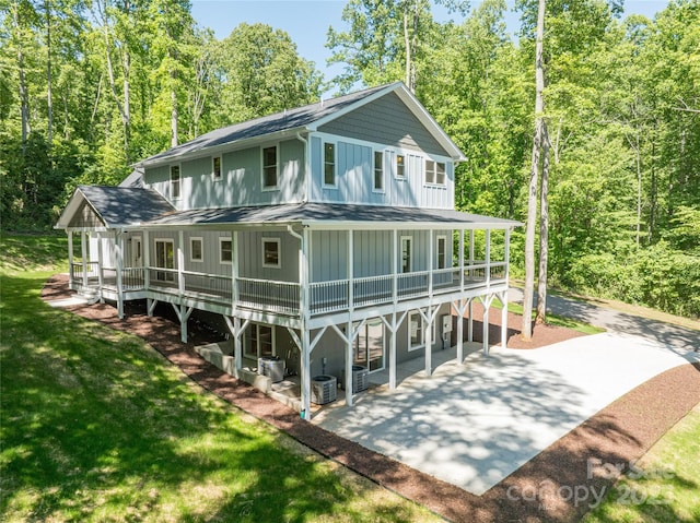 68 Bamboo Trl, Candler, NC 28715 - rear view of property with board and batten siding, a patio area, a lawn, a shingled roof, and a deck