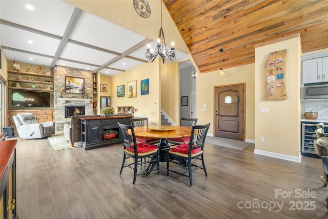 134 Olivia Trace Dr, Fletcher, NC 28732 - dining room with wine cooler, a stone fireplace, wood finished floors, stairway, and recessed lighting