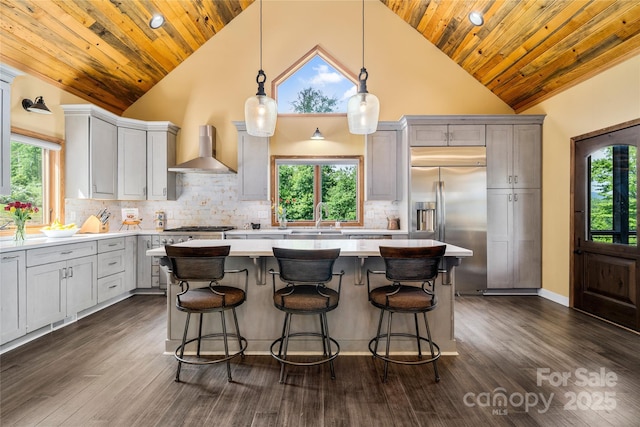 134 Olivia Trace Dr, Fletcher, NC 28732 - kitchen with wall chimney range hood, stainless steel appliances, light countertops, a center island, and wooden ceiling