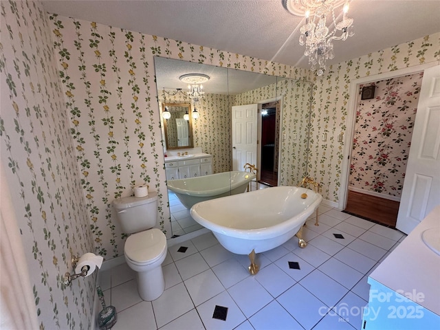 5495 Valley Run St, Hickory, NC 28601 - bathroom with wallpapered walls, baseboards, a chandelier, a freestanding bath, and tile patterned floors