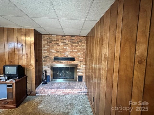 5495 Valley Run St, Hickory, NC 28601 - unfurnished living room with wood walls, a brick fireplace, and a paneled ceiling