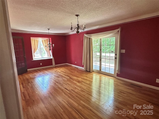 5495 Valley Run St, Hickory, NC 28601 - unfurnished room with a textured ceiling, a chandelier, wood finished floors, and ornamental molding