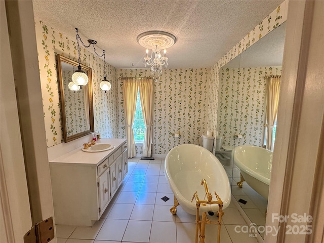 5495 Valley Run St, Hickory, NC 28601 - bathroom with wallpapered walls, a freestanding tub, tile patterned flooring, a chandelier, and a textured ceiling