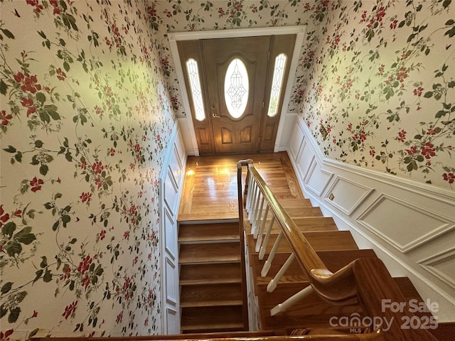 5495 Valley Run St, Hickory, NC 28601 - entryway featuring wallpapered walls, a wainscoted wall, light wood-type flooring, stairs, and a decorative wall
