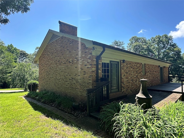 5495 Valley Run St, Hickory, NC 28601 - view of home's exterior featuring brick siding, a lawn, a deck, and a chimney