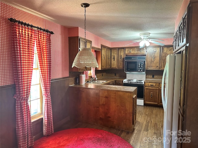 5495 Valley Run St, Hickory, NC 28601 - kitchen with white appliances, a peninsula, dark wood-type flooring, wallpapered walls, and a textured ceiling