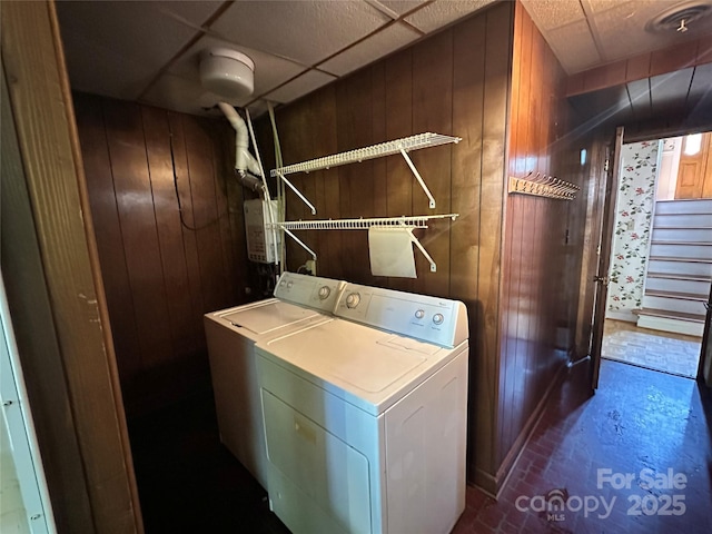 5495 Valley Run St, Hickory, NC 28601 - laundry area with wood walls, brick patterned floors, and washer and clothes dryer
