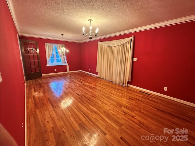 5495 Valley Run St, Hickory, NC 28601 - spare room featuring a chandelier, wood finished floors, a textured ceiling, and crown molding