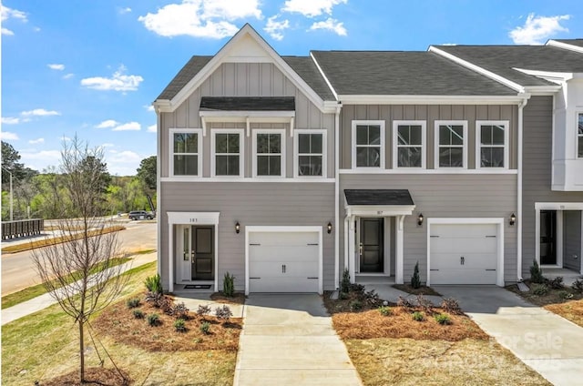 2712 Lehigh Rd, Charlotte, NC 28208 - view of front of home with board and batten siding, concrete driveway, a garage, and roof with shingles