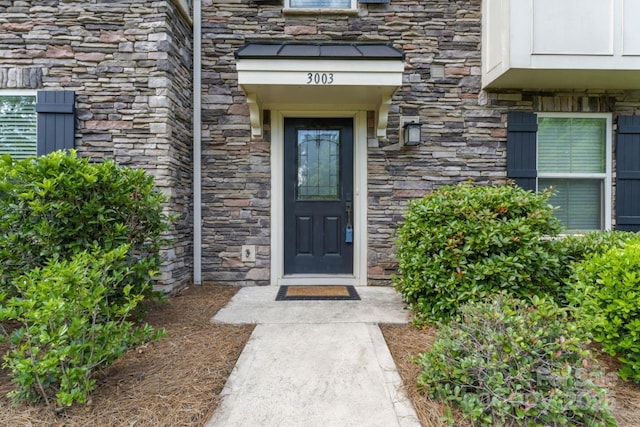 entrance to property with stone siding