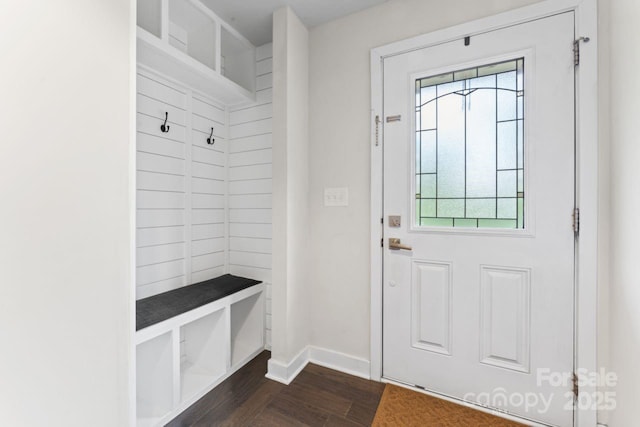 mudroom with dark wood-style flooring and baseboards