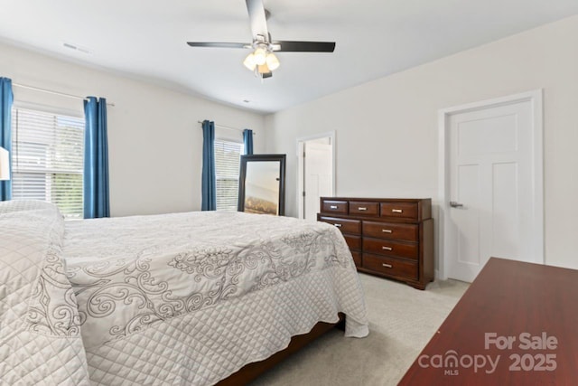 bedroom featuring light colored carpet and ceiling fan