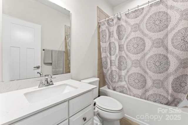 bathroom featuring toilet, shower / tub combo, and vanity