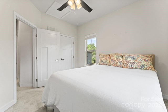 bedroom featuring light carpet, baseboards, and ceiling fan