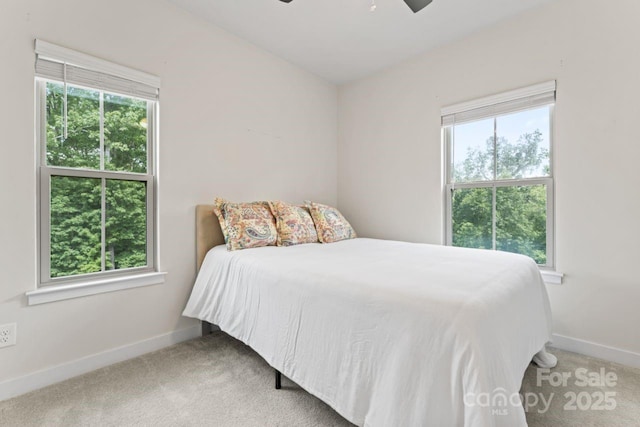 bedroom with baseboards, carpet floors, and a ceiling fan