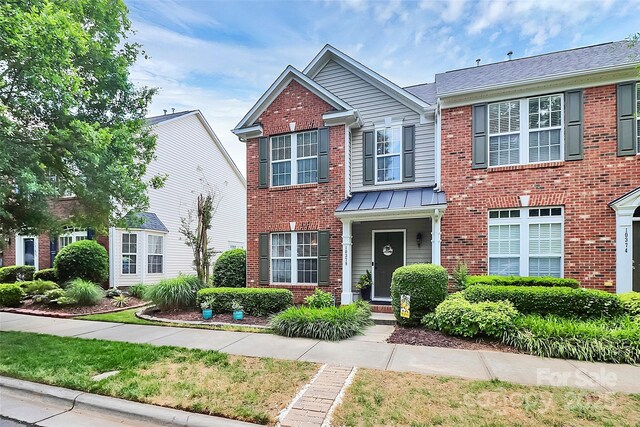 10378 Alexander Martin Ave, Charlotte, NC 28277 - view of front facade with brick siding and a standing seam roof