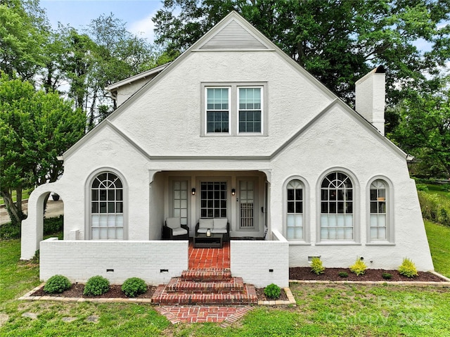 415 Norwood St SW, Lenoir, NC 28645 - view of front facade with covered porch, a chimney, a front yard, and stucco siding