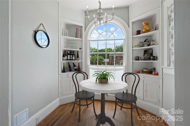 415 Norwood St SW, Lenoir, NC 28645 - dining room with a chandelier, wood finished floors, and built in shelves