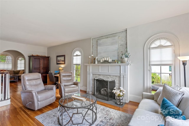 415 Norwood St SW, Lenoir, NC 28645 - living room featuring plenty of natural light, arched walkways, wood finished floors, and a fireplace