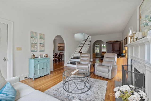 415 Norwood St SW, Lenoir, NC 28645 - living area with arched walkways, stairs, and light wood finished floors