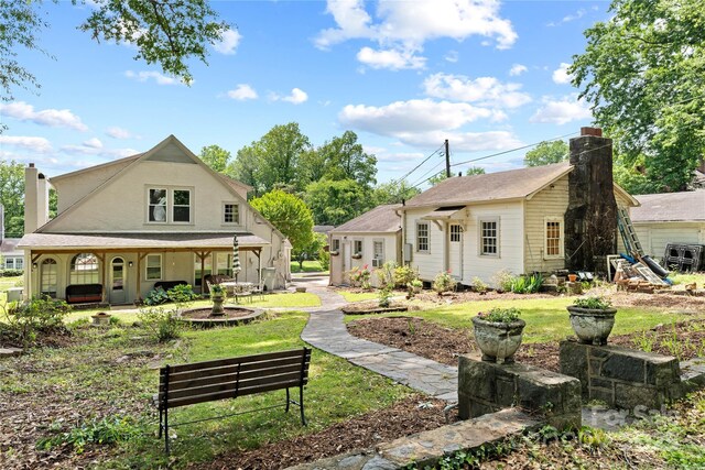 415 Norwood St SW, Lenoir, NC 28645 - rear view of house with a chimney, a porch, and a lawn