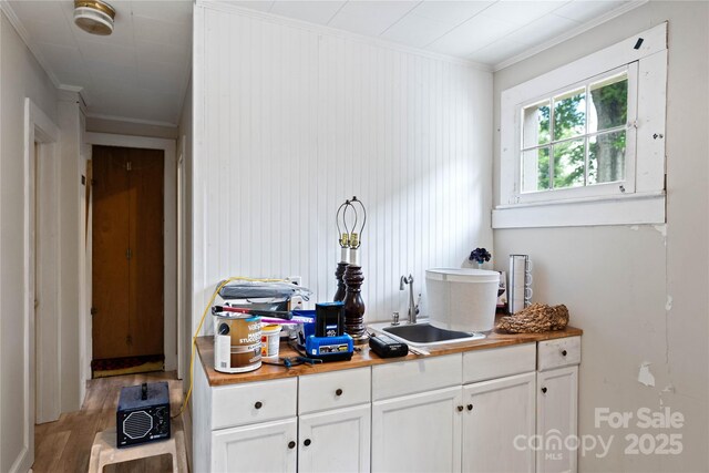 415 Norwood St SW, Lenoir, NC 28645 - kitchen with a sink, light wood finished floors, crown molding, white cabinetry, and butcher block countertops