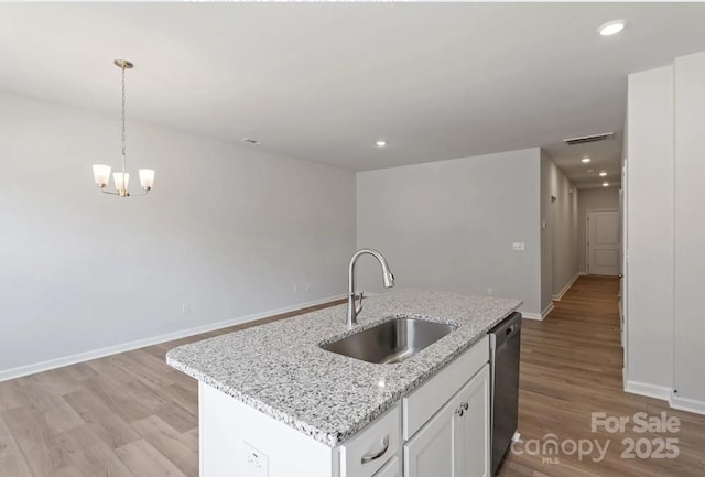 kitchen featuring a sink, dishwasher, light wood-style flooring, a chandelier, and recessed lighting