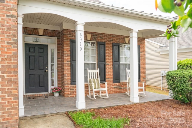 6310 Highland Commons Rd, Charlotte, NC 28269 - property entrance with covered porch and brick siding
