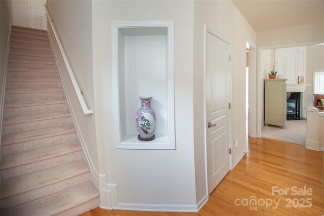 6310 Highland Commons Rd, Charlotte, NC 28269 - stairs with a high end fireplace, wood finished floors, and baseboards