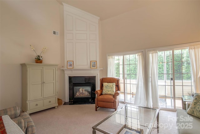 6310 Highland Commons Rd, Charlotte, NC 28269 - carpeted living room featuring a fireplace with flush hearth and a high ceiling