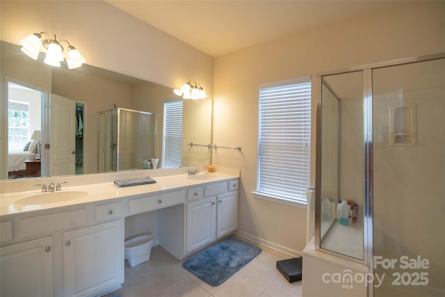 6310 Highland Commons Rd, Charlotte, NC 28269 - bathroom featuring a shower stall, tile patterned flooring, double vanity, baseboards, and connected bathroom