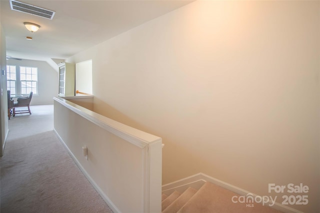 6310 Highland Commons Rd, Charlotte, NC 28269 - hallway with light colored carpet, baseboards, and an upstairs landing
